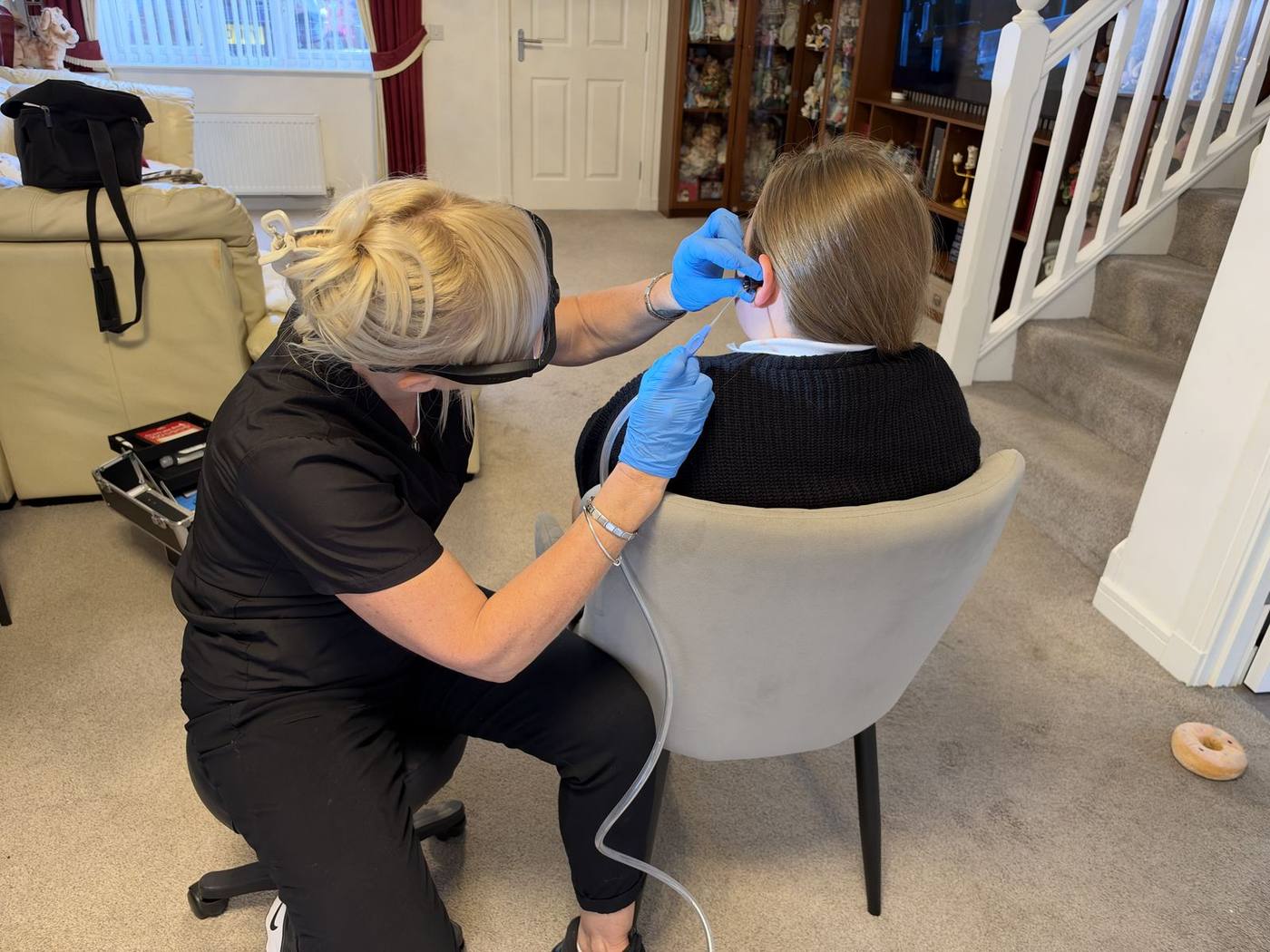 Jackie carrying out ear wax removal at a client's home
