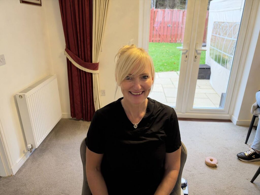 Jackie, micro suction practitioner, smiling at a client's home