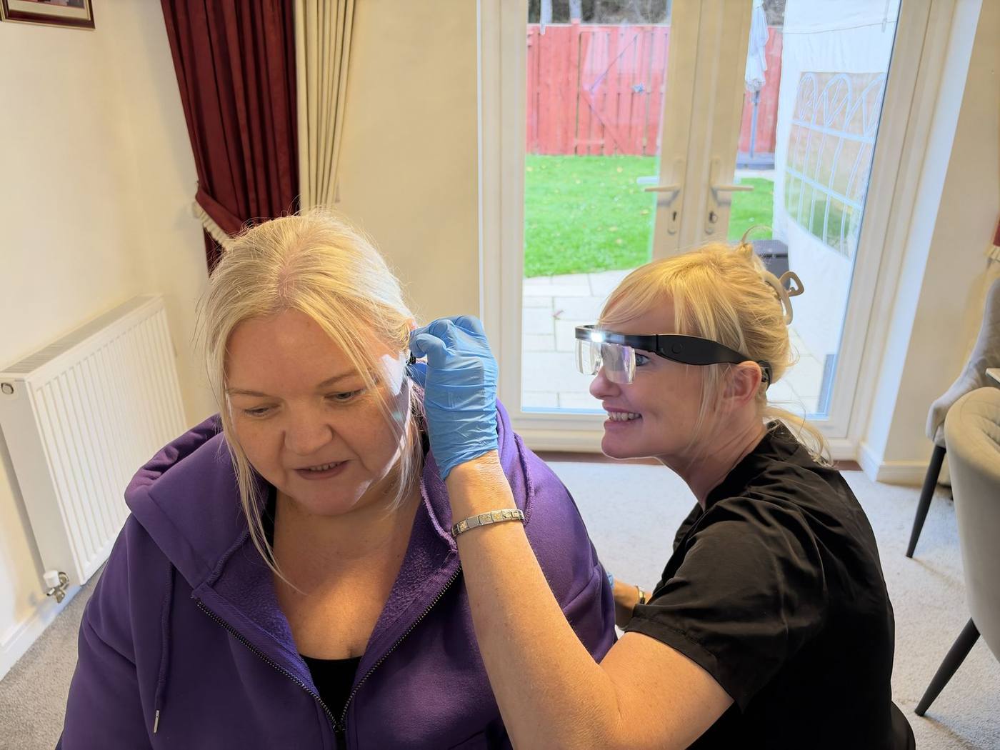 Jackie with a smiling client during an ear wax removal home visit