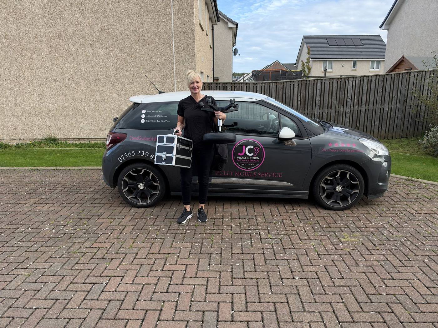 Jackie with her branded JC Micro Suction car and equipment