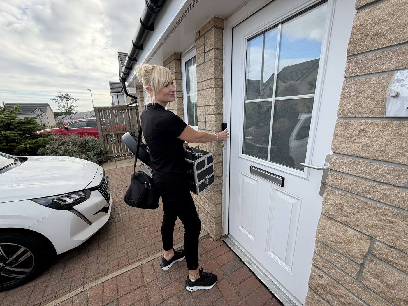 Jackie arriving at a client's front door for a home ear wax removal visit